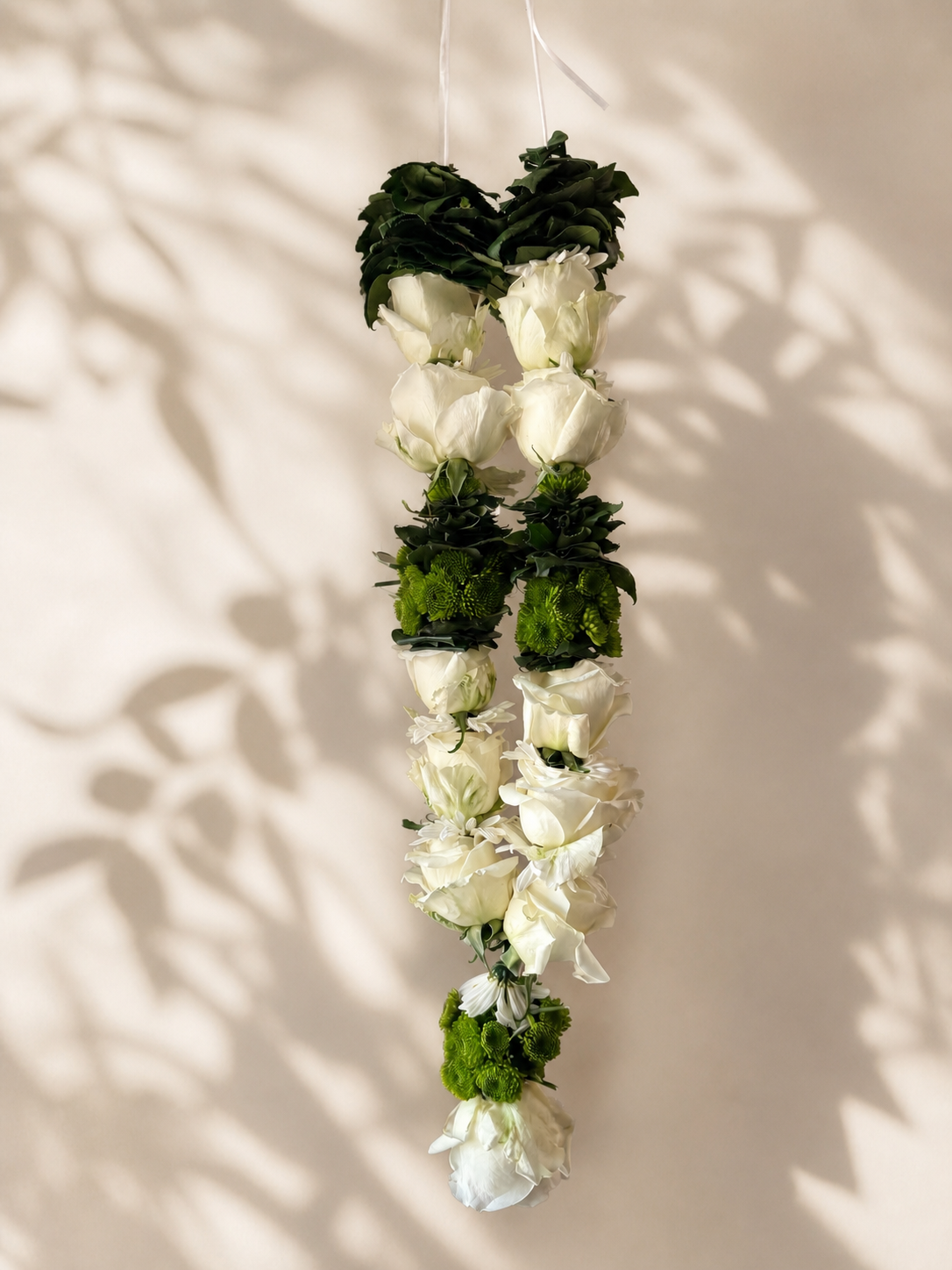 Ivory and green hanging garland alternate product view on ivory leaf-shadow backdrop