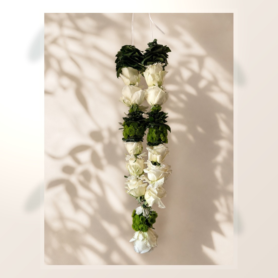 Ivory and green hanging garland alternate product view on ivory leaf-shadow backdrop