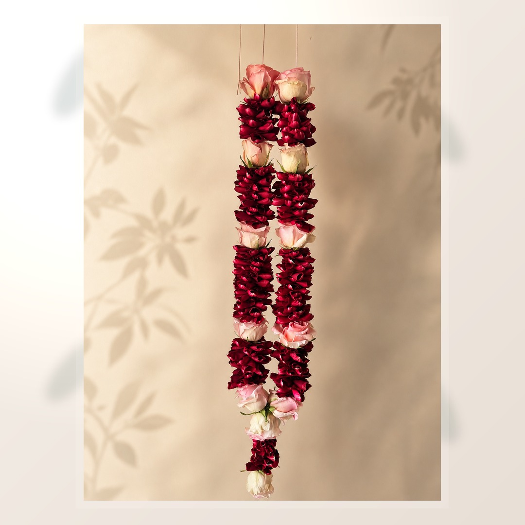 Ruby and pink rose petal mala alternate product view on ivory leaf-shadow backdrop