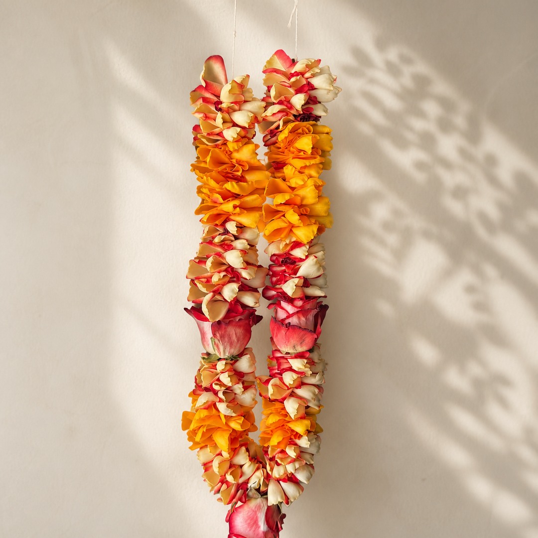 Close alternate view of sunset orange, yellow, cream, and pink rose petal garland