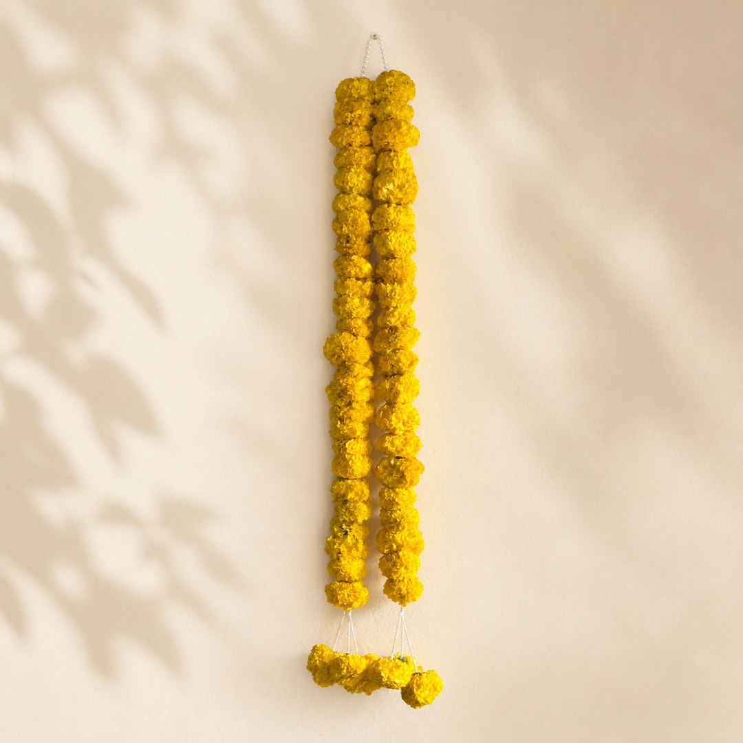 Alternate view of golden yellow marigold garland with pearl loop