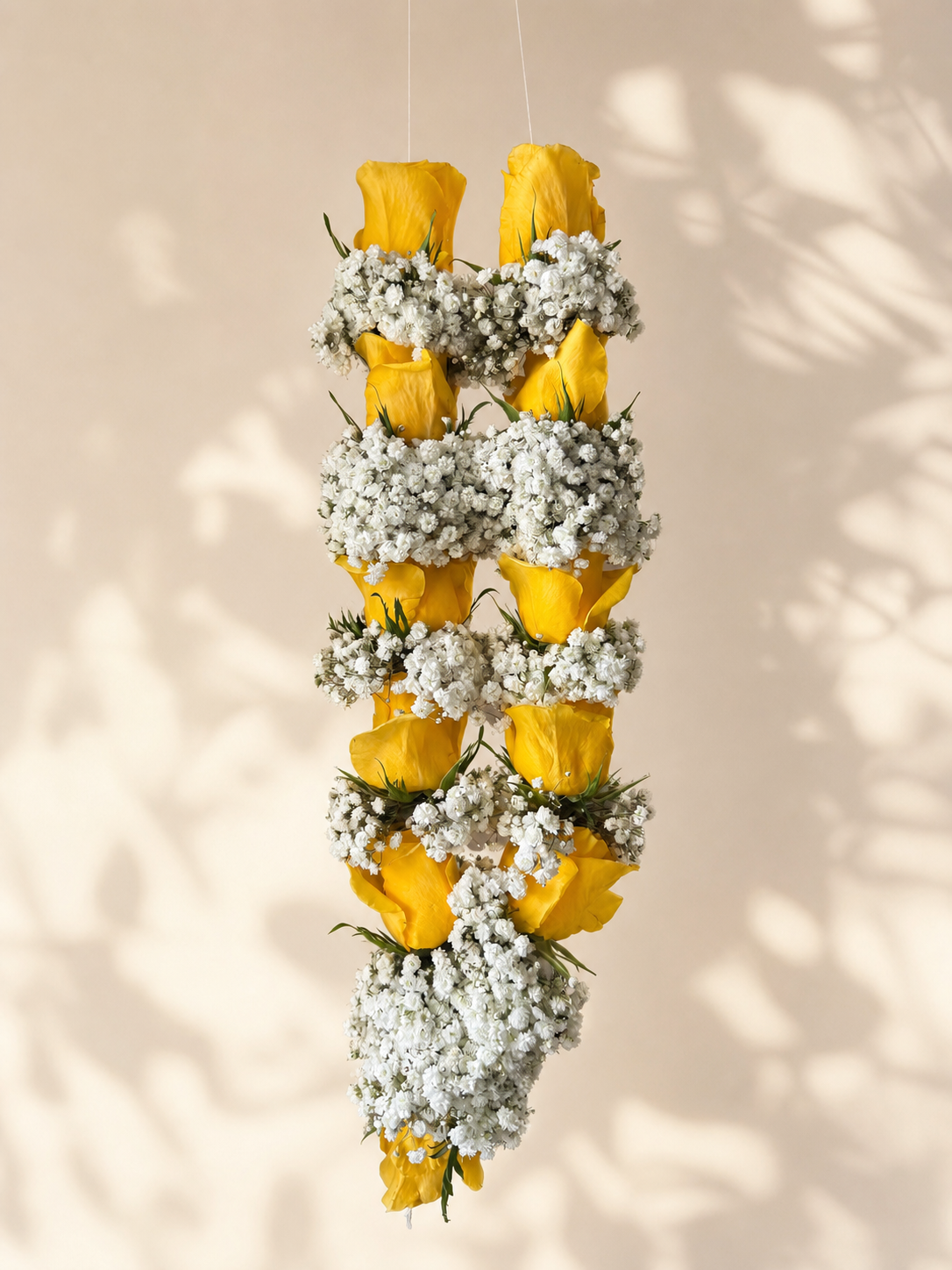 Golden yellow rose and baby's breath garland alternate product view on clean ivory backdrop